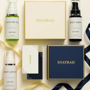 Flatlay of Snayrah gift boxes with skincare bottles and ribbons – Aloe Vera Gel, Body Wash & Body Lotion