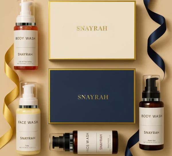 Two skincare gift boxes in cream and royal blue with SNAYRAH logo and ribbon, placed side by side