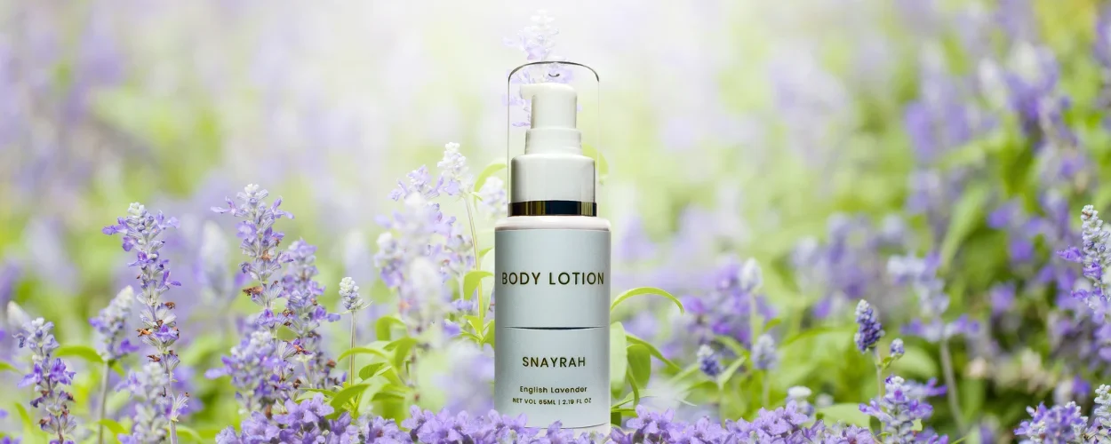 Snayrah Body Lotion for Her with English Lavender fragrance, featuring lavender flowers for illustration.